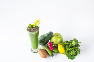 Green smoothie with antioxidant drink prepared with green fruits and vegetables against a white background.