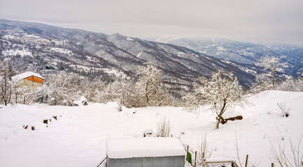 Wintertime snowy panorama of the hills of the Oltrepo Pavese Region (Lombardy, Northern Italy); It's know for its production of valuable red and sparkling wines.