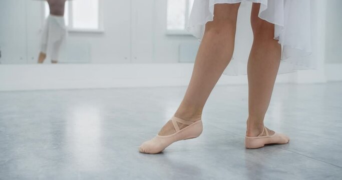 Close up shot of ballerina's pointe shoes, woman dance on her toes in slow motion, rehearsal at the ballet class, dancing practice, 4k 60p Prores HQ