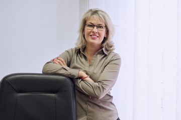 Portrait of confident middle aged business woman in an office workplace