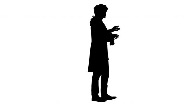 Silhouette Man in old-fashioned frock coat and white wig talking and waiving with his hands theatrically looking at camera.