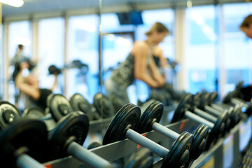 Metal dumbbells for strength training in the gym.
