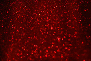 Blurred bokeh background Luxury Red bokeh lovely background. Sparkle red texture, Valentine or Christmas  wallpaper, glitter backdrop. Festive abstraction. Shiny fabric with sequins.