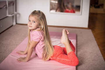 Little girl working exercise in her bedroom.
