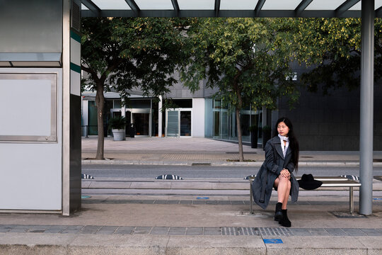 tram stop with asian woman waiting for the train