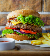 Burger with red sauce and French fries .