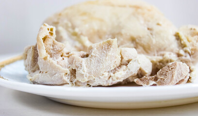 Pieces of boiled meat on a plate. Chicken fillet and pork.