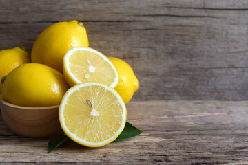Fresh lemon and sliced on the wooden table,copy space.