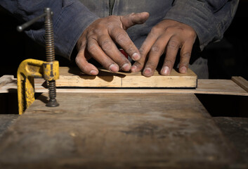 detail of carpenter's hands working in a carpentry shop