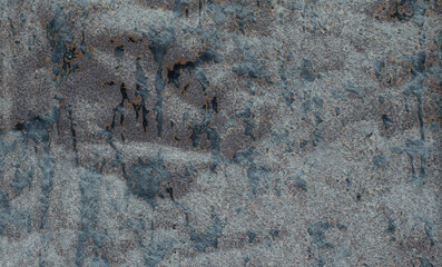 The surface of old metal objects that are rusty and black stained