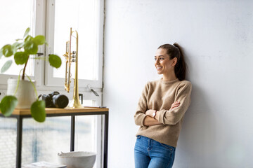 Portrait of a smiling creative woman in a modern loft space
