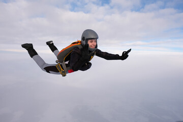 Skydiving. A pretty girl is flying in the sky.