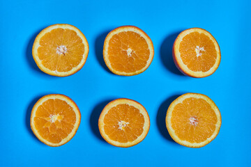 Orange slices on a blue background. CITRUS CITRIC