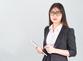 Asain women in suit standing using her digital tablet computer