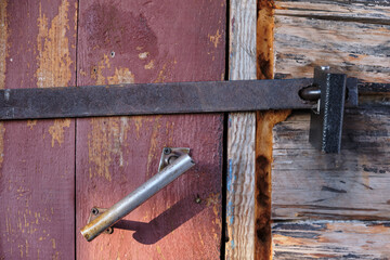 background of old wooden door with handle and metal lock