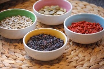 A healthy meal, simple ingredients: goji berries, black rice. Photo taken on a bamboo mat.