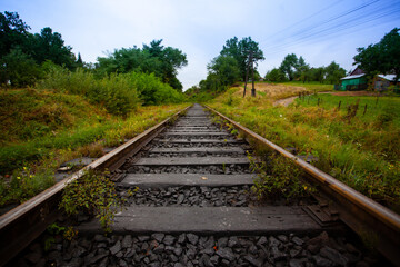 Obraz premium Railway in the mountains scenic views tourist route green landscape fluffy forest settlements Carpathians