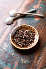 Dry root of Rhodiola rosea. Golden root, rose root. Healthy medical plant on wooden background. Close up. 