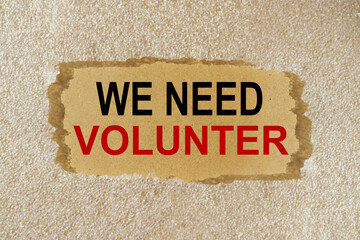 we need volunter, text on wood board in black and red letters