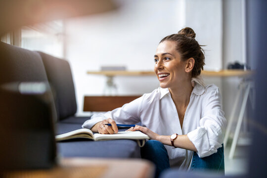 Young female freelancer working in loft office
