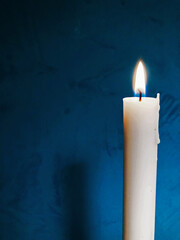 Light candle, on dark aquamarine background.
Candle light in black background.