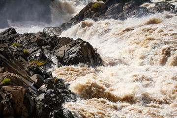 Mekong river, Laos. Fish trap on the rocks surrounded by Mekong rapids.