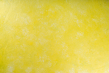 Textured background of yellow concrete wall
