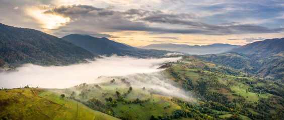 forested hills in rising fog. Mountain sunset hills.