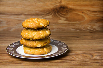 Shortbread cookies with peanuts on a wooden table. Homemade baking.