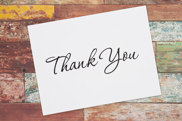 White Thank You greeting card on wood