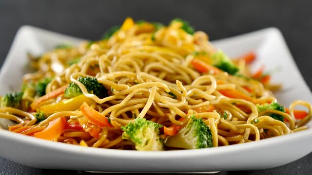 eating fried noodles with vegetable