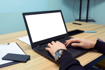 Male hands typing on laptop keyboard with isolated screen in office. Office, business and technology concept