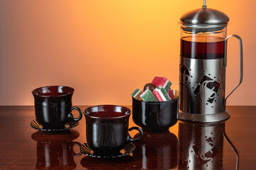 French with tea and glass mugs. Black tea mugs. Black glass service.