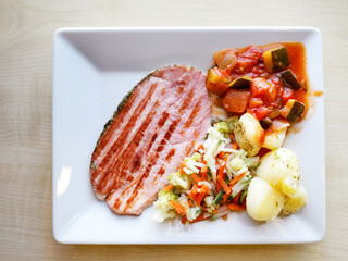 Salad with speck ham and egg, tomatoes