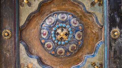 Vintage Chinese style painted wood decoration on an old teak door panel.