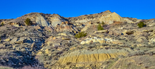 Geological stony-clay landscape, mountains and rocks in the evening at sunset. North Dakota
