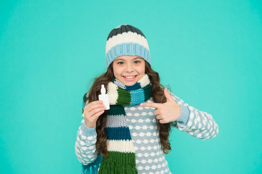 Pretty Child Girl With Thumb Up In Knitted Warm Clothes Use Nasal Spray, Covid Treatment.