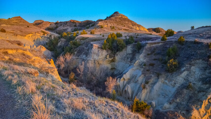 Geological stony-clay landscape, mountains and rocks in the evening at sunset. North Dakota