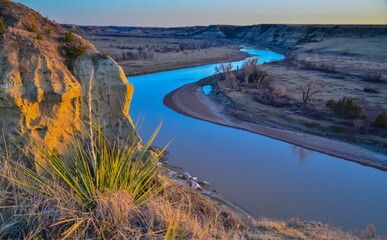 View of the winding river from the mountain in the evening at sunset. North Dakota