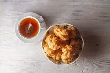 Custard cookies eclair on the table with a cup of tea for breakfast