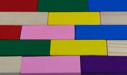 Colourful wooden blocks arranged in a pattern, background.