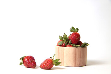 wooden bowl of strawberry isolated on white background. Harvesting concept