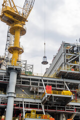 A personal-transfer-basket being used for transfer of offshore crew from an oil production platform...