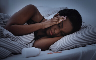 Tired sad millennial african american woman with closed eyes presses hands to temples and suffers from headache