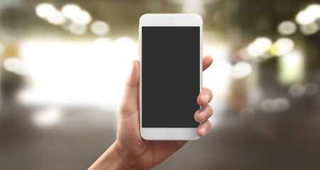 Hand holding smartphone device touching screen