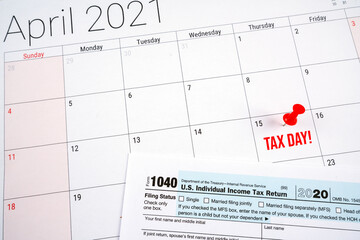 us individual income tax return 1040 form for 2020 with tax day text and red pin on april 15th on...