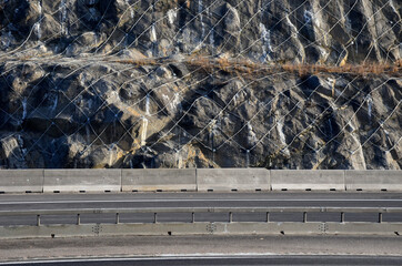 strengthening the slope with a steel net anchored deep into the rock. falling rocks do not fall on...