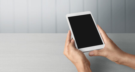 Hands holding  tablet touch computer gadget with  screen