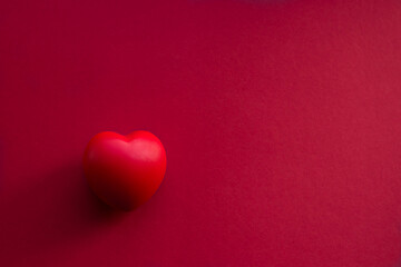 Red volumetric heart on a red background horizontal photo with place for text