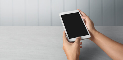 Hands holding  tablet touch computer gadget with  screen